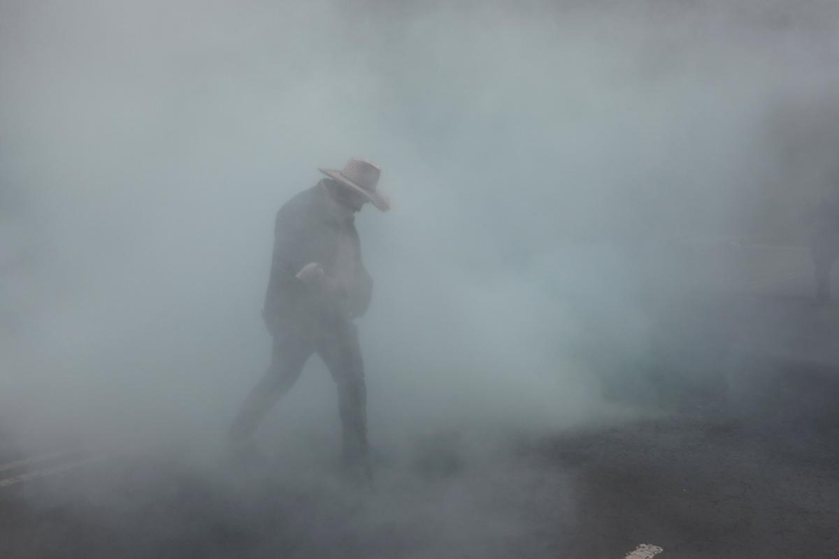 A dissident teacher from Mexico's National Coordination of Education Workers (CNTE) walks amid tear gas outside the Secretariat of Public Education (SEP) during a protest to demand better wages and pensions, under the slogan "If there's no solution, the ball won't roll," ahead of the 2026 FIFA World Cup, in Mexico City, Mexico, June 3, 2026. REUTERS/Paola Garcia