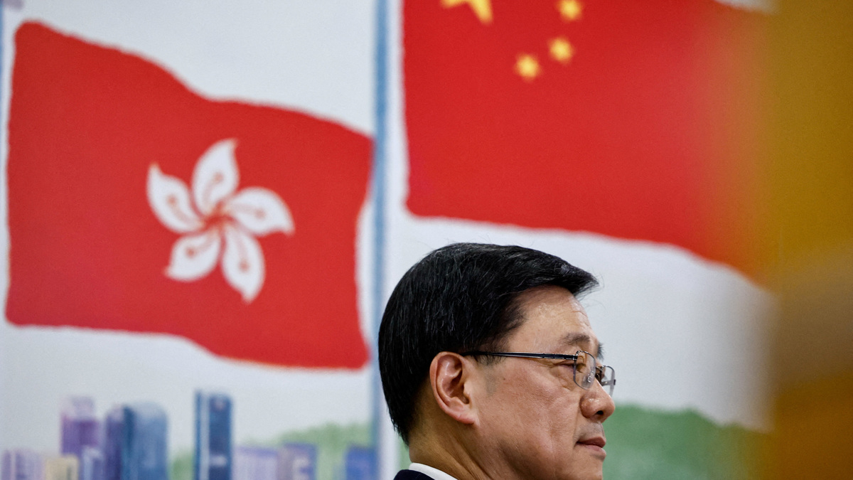 FILE PHOTO: Chief Executive of Hong Kong John Lee attends a press conference in Beijing, China December 16, 2025. REUTERS/Tingshu Wang/File Photo