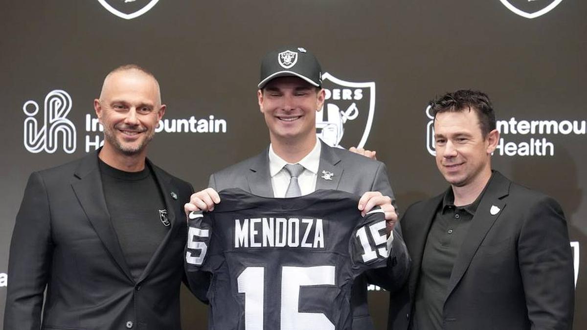  Apr 24, 2026; Henderson, NV, USA; Las Vegas Raiders quarterback Fernando Mendoza (center) poses with general manager John Spytek (left) and head coach Klint Kubiak at introductory press conference at Intermountain Health Performance Center after being selected as the No. 1 pick in the 2026 NFL Draft. Mandatory Credit: Kirby Lee-Imagn Images | Kirby Lee-Imagn Images 
