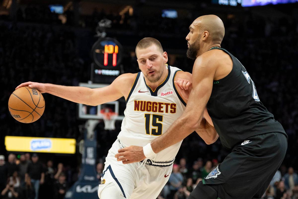  Denver Nuggets center Nikola Jokic dribbles the ball against Minnesota Timberwolves center Rudy Gobert. Jesse Johnson-Imagn Images