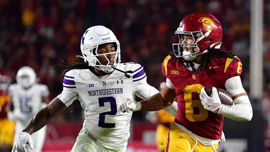  Nov 7, 2025; Los Angeles, California, USA; Southern California Trojans wide receiver Makai Lemon (6) runs the ball against Northwestern Wildcats cornerback Fred Davis II (2) during the second half at the Los Angeles Memorial Coliseum. Mandatory Credit: Gary A. Vasquez-Imagn Images | Gary A. Vasquez-Imagn Images 