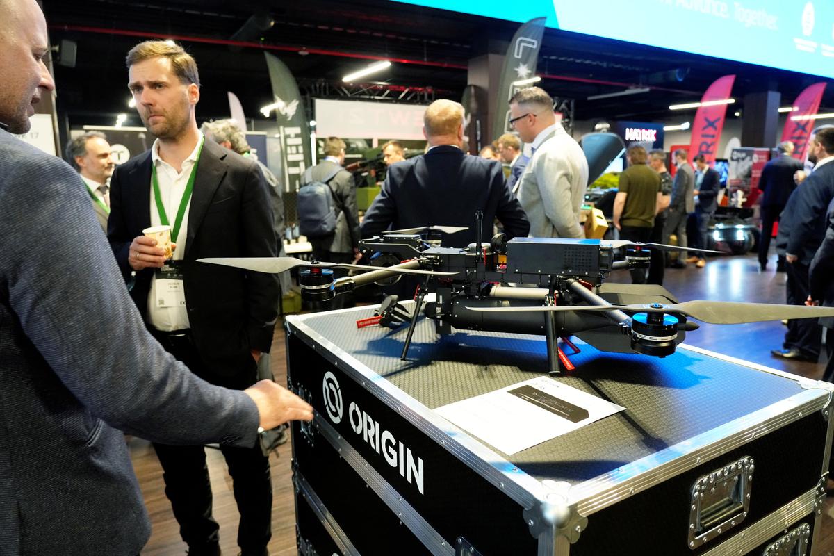 People stand next to Origin's man-portable drone Beak displayed during the international Drone Summit in Riga, Latvia May 27, 2026. REUTERS/Ints Kalnins