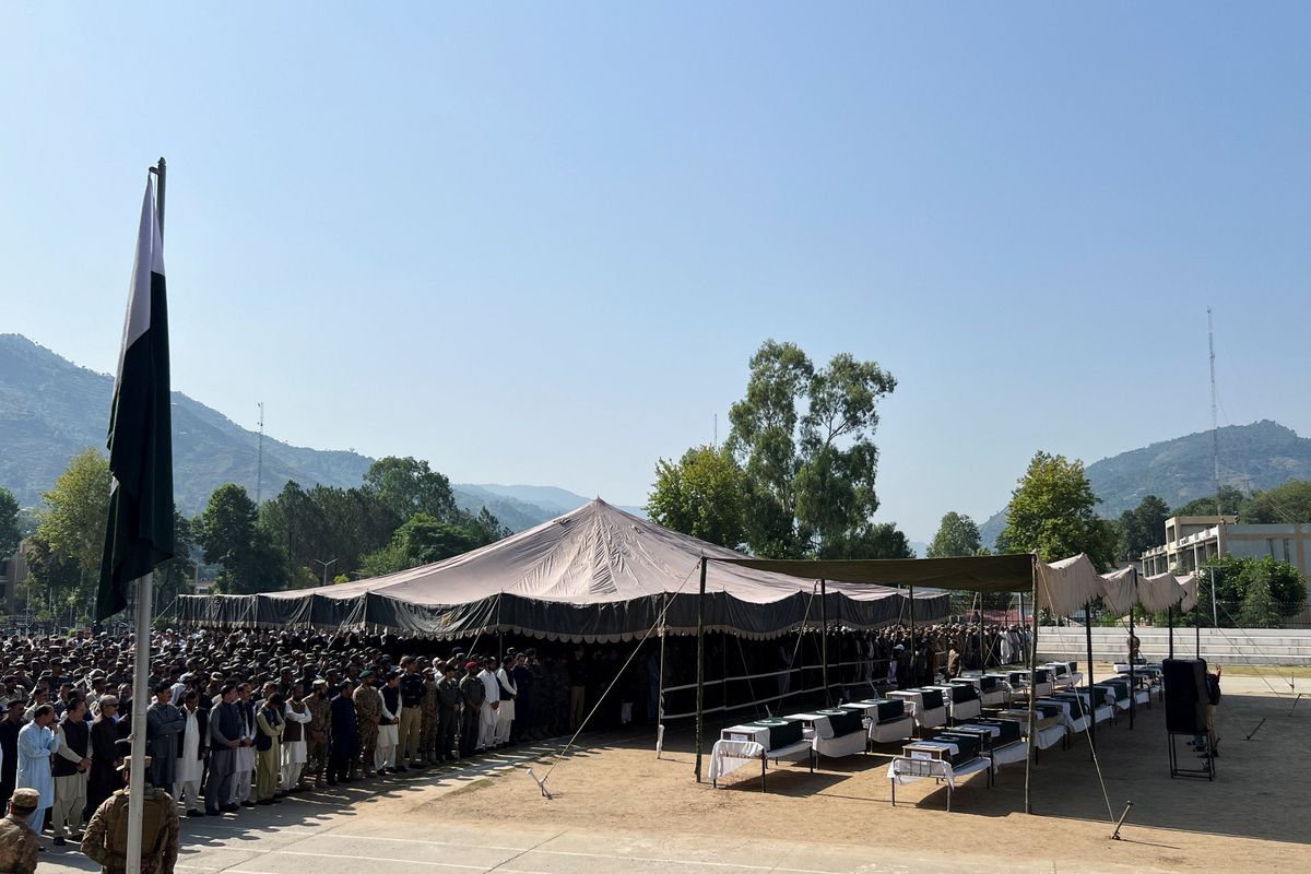 Pakistani Army officers and people offer prayers as they attend the funeral of the victims, who died after an Mi-17 helicopter of Pakistan Army Aviation crashed near Muzaffarabad on Wednesday during take-off, in Muzaffarabad, Pakistani Kashmir, June 11, 2026. Picture taken with a mobile phone. REUTERS/Naseer ud Din