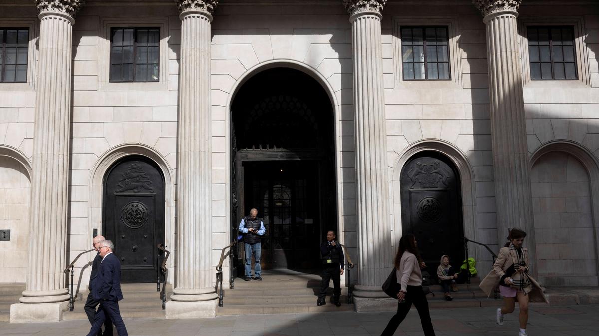 People walk outside the Bank of England building in London, Britain, April 14, 2025. REUTERS/Carlos Jasso