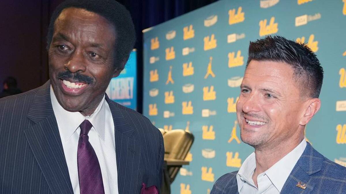  Dec 9, 2025; Los Angeles, CA, USA; UCLA Bruins football coach Bob Chesney (right) with CBS Los Angeles sports director Jim Hill at introductory press conference at Renee Luskin Conference Center Centennial Ballroom. Mandatory Credit: Kirby Lee-Imagn Images | Kirby Lee-Imagn Images 