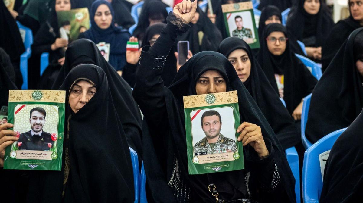 Iranian women carry photographs of relatives killed in the war Sunday. Negotiators have come to a cease-fire agreement between the United States and Iran, but President Donald Trump and Iranian leadership haven't yet approved it. Photo by Behnam Tofighi/UPI