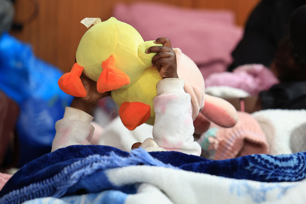 A migrant child plays with her toy while sheltering in a hall with her family, following an escalation in anti-immigrant protests which heightened fears among foreign communities, in Kleinmond, South Africa, June 3, 2026. REUTERS/Esa Alexander