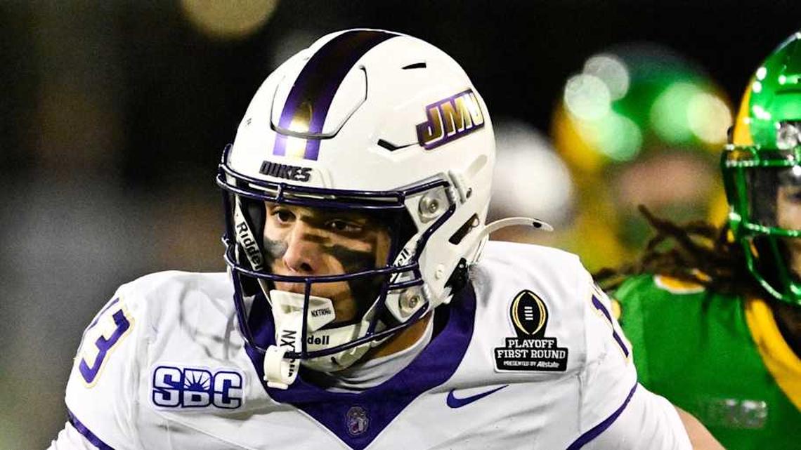  Dec 20, 2025; Eugene, OR, USA; James Madison Dukes wide receiver Landon Ellis (13) runs after making a catch as Oregon Ducks defensive back Theran Johnson (5) defends during the second quarter at Autzen Stadium. Mandatory Credit: Troy Wayrynen-Imagn Images | Troy Wayrynen-Imagn Images 