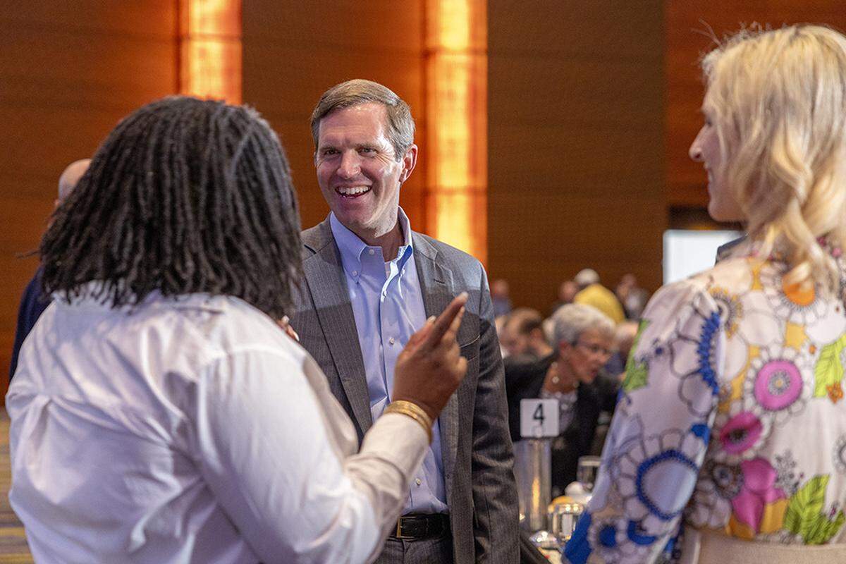 Kentucky Gov. Andy Beshear speaks with attendees during the Iowa Democratic Party’s annual Liberty and Justice Celebration in Des Moines on July 27. Beshear has fans among the party’s more liberal and more centrist contributors.