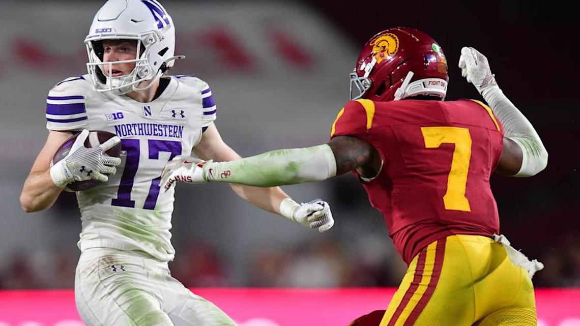  Nov 7, 2025; Los Angeles, California, USA; Northwestern Wildcats wide receiver Griffin Wilde (17) runs the ball against Southern California Trojans safety Kamari Ramsey (7) during the second half at the Los Angeles Memorial Coliseum. Mandatory Credit: Gary A. Vasquez-Imagn Images | Gary A. Vasquez-Imagn Images 