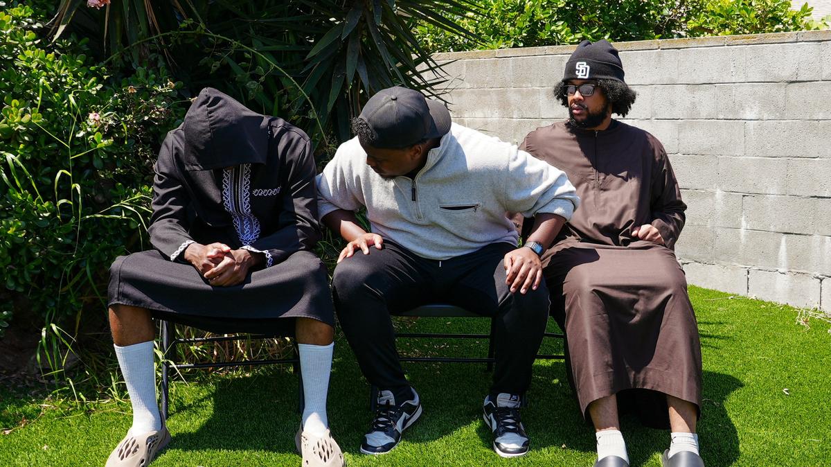 Jibril Abdullah, Mohammed Abdullah and Khalid Abdullah, sons of security guard Amin Abdullah, who was killed in a shooting incident, sit outside their home in San Diego, California, U.S., May 20, 2026. REUTERS/Arafat Barbakh