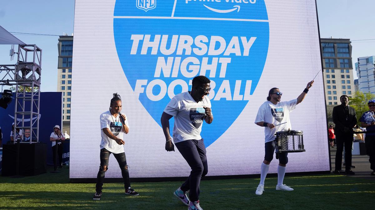 FILE - Robert “Bojo” Ackah, center, and Fik-Shun, left, perform during the announcement of the first Thursday Night Football on Prime Video matchup featuring the San Diego Chargers at Kansas City Chiefs at the 2022 NFL Draft on Thursday, April 28, 2022 in Las Vegas. The Thursday night, Sept. 15 game between the Los Angeles Chargers and Kansas City Chiefs kicks off Amazon Prime Video’s 11-year agreement with the NFL to carry “Thursday Night Football”. (AP Photo/Vera Nieuwenhuis, File)