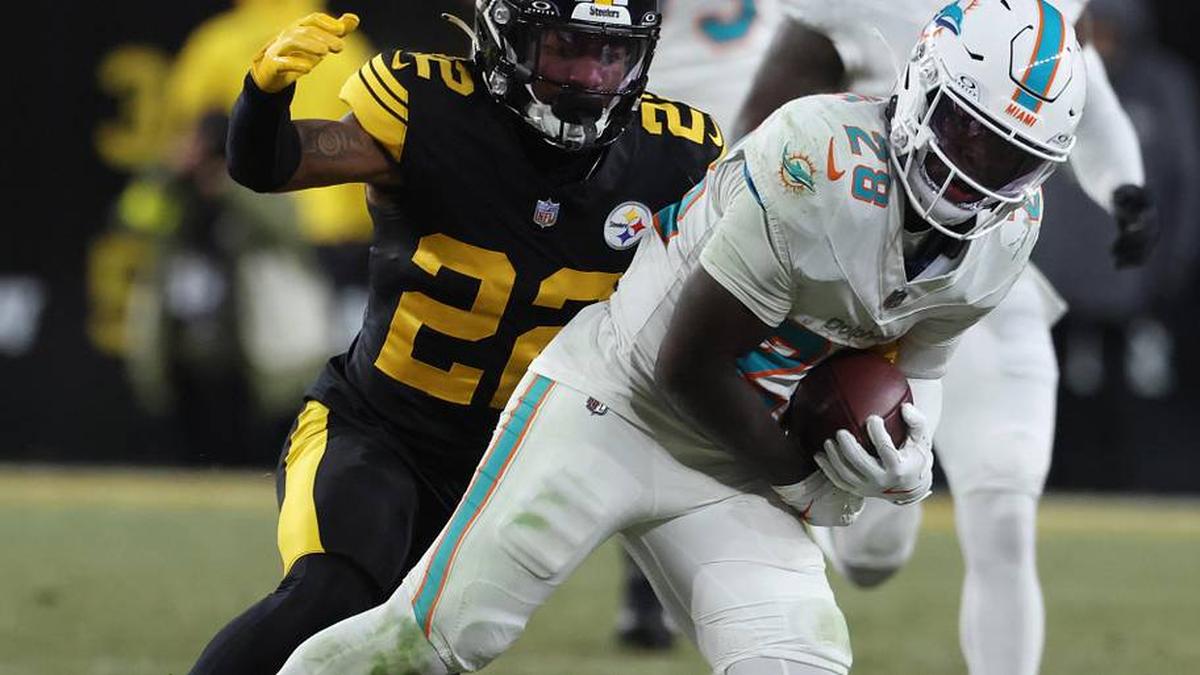 Dec 15, 2025; Pittsburgh, Pennsylvania, USA; Miami Dolphins running back De'Von Achane (28) is tackled by Pittsburgh Steelers cornerback Asante Samuel Jr. (22) in the second quarter at Acrisure Stadium. Mandatory Credit: Charles LeClaire-Imagn Images | Charles LeClaire-Imagn Images 