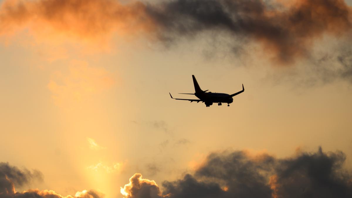 A plane makes its descent into Oakland International Airport at sunset as seen from Marina Park in San Leandro, Calif., on Tuesday, April 1, 2025. (Jane Tyska/Bay Area News Group)