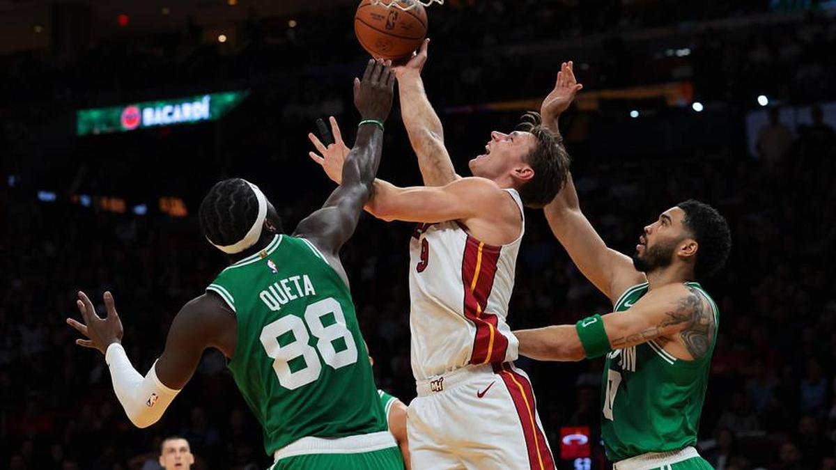  Apr 1, 2026; Miami, Florida, USA; Miami Heat guard Pelle Larsson (9) drives to the basket against Boston Celtics center Neemias Queta (88) and forward Jayson Tatum (0) at Kaseya Center. Mandatory Credit: Sam Navarro-Imagn Images | Sam Navarro-Imagn Images 