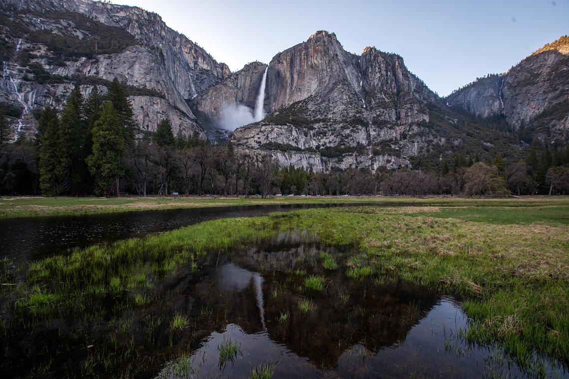 The waterfall is reflected in water in the meadow in the Yosemite Valley as the snowpact melts on April 26, 2023, in Yosemite National Park, California. 