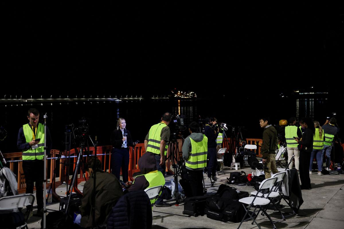 Members of the media await the arrival of the cruise ship MV Hondius at the port of Granadilla de Abona after being affected by a hantavirus outbreak, in Tenerife, Spain, May 10, 2026. REUTERS/Hannah McKay