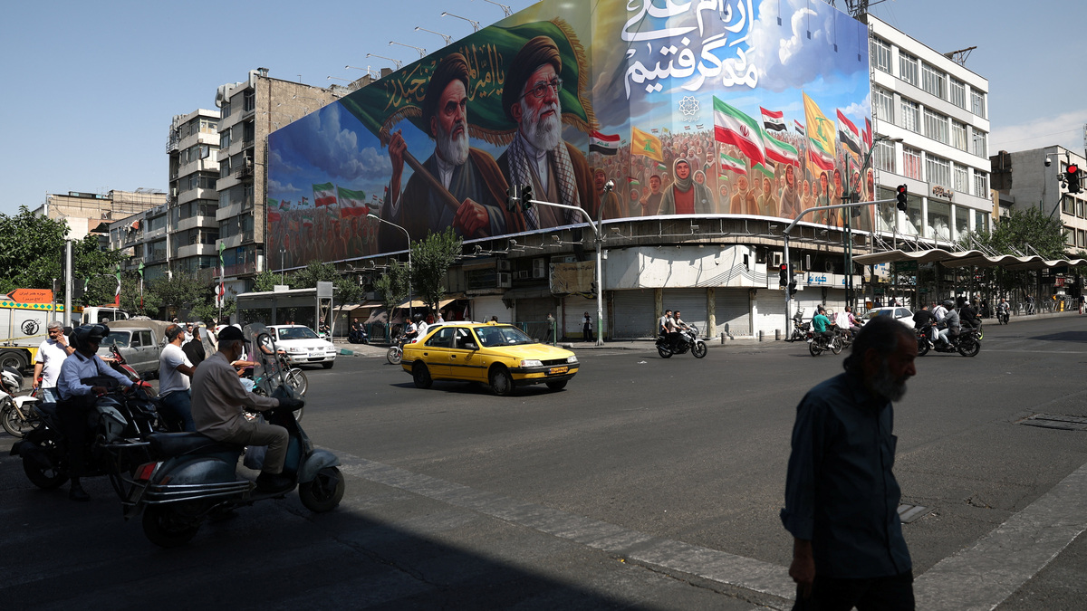 People walk past a billboard depicting the late leader of the Islamic Revolution, Ayatollah Ruhollah Khomeini, and the late Iran's Supreme Leader Ayatollah Ali Khamenei, on a street in Tehran, Iran, June 10, 2026. Majid Asgaripour/WANA (West Asia News Agency) via REUTERS