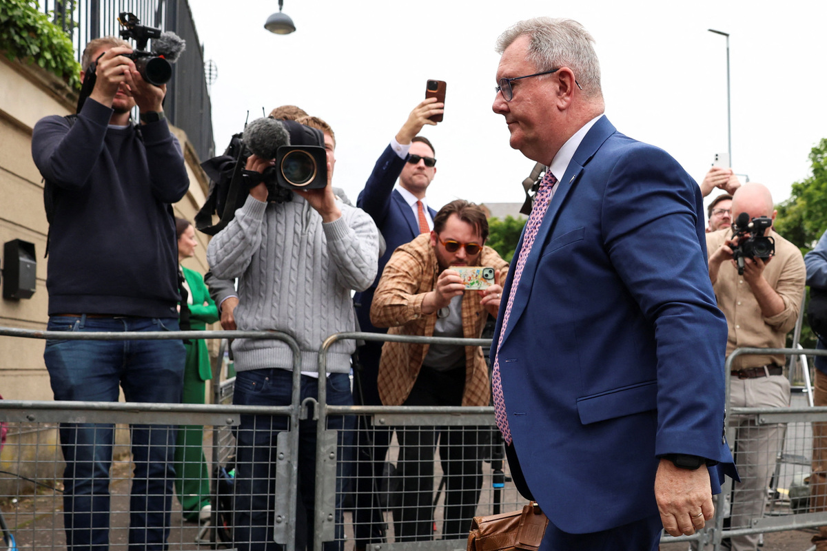 Jeffrey Donaldson, former leader of the Democratic Unionist Party (DUP), charged with historical sex offences, walks outside the Newry Courthouse as his trial continues, in Newry, Northern Ireland, June 22, 2026. REUTERS/Cathal McNaughton