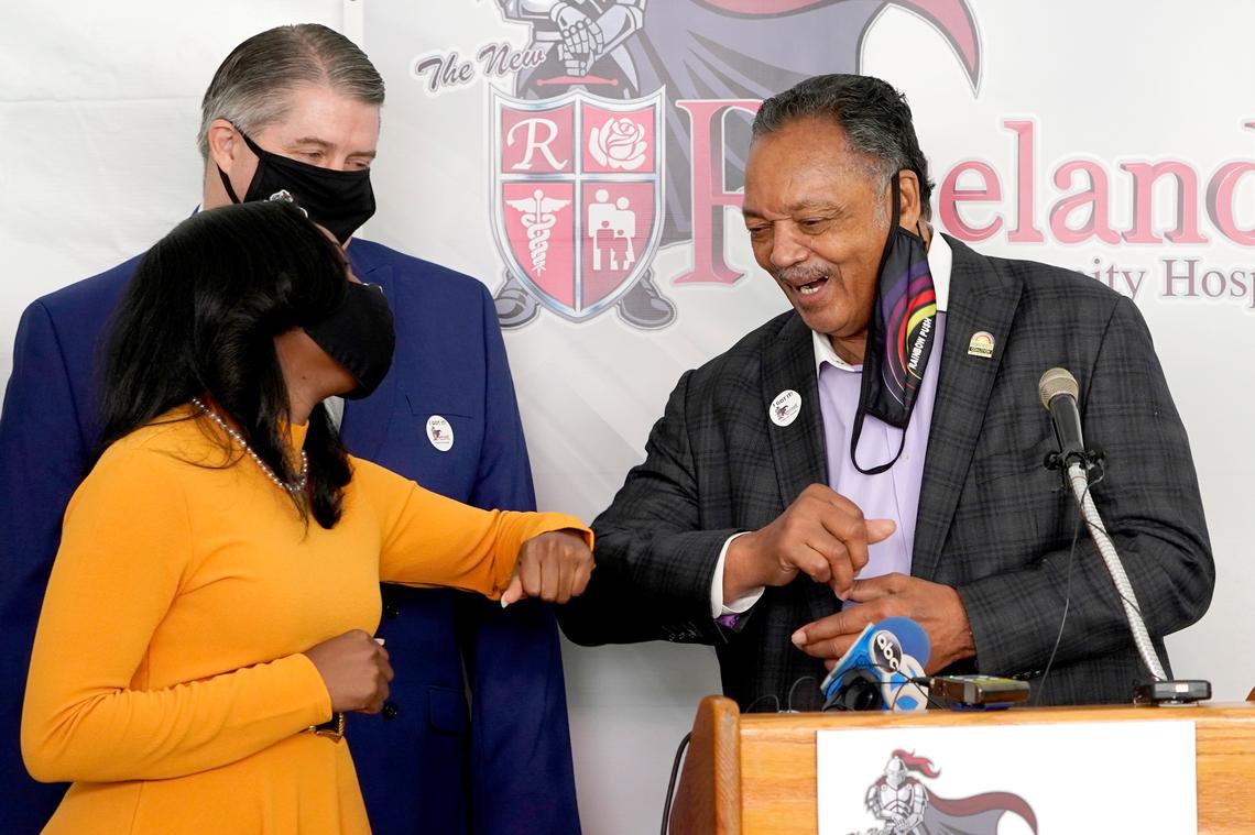 Rev. Jesse Jackson, bumps elbows with Kizzmekia Corbett, an immunologist with the Vaccine Research Center at the National Institute of Health Friday, Jan. 8, 2021, after receiving Pfizer’s BioNTech COVID-19 vaccine at the Roseland Community Hospital in Chicago. (AP Photo/Charles Rex Arbogast)