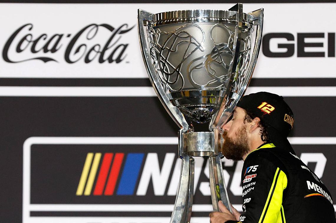  AVONDALE, ARIZONA - NOVEMBER 05: Ryan Blaney, driver of the #12 Menards/Dutch Boy Ford, kisses the Bill France NASCAR Cup Series Championship trophy in victory lane after winning the 2023 NASCAR Cup Series Championship, finishing first of the Championship 4 drivers in the NASCAR Cup Series Championship race at Phoenix Raceway on November 05, 2023 in Avondale, Arizona. (Photo by Sean Gardner/Getty Images) 