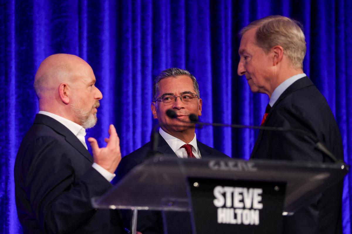 FILE PHOTO: Candidates Steve Hilton, Xavier Becerra and Tom Steyer talk at the end of a debate in the race for governor of California, hosted by the San Francisco Examiner and CBS, in San Francisco, California, U.S., May 14, 2026. REUTERS/Carlos Barria/File Photo