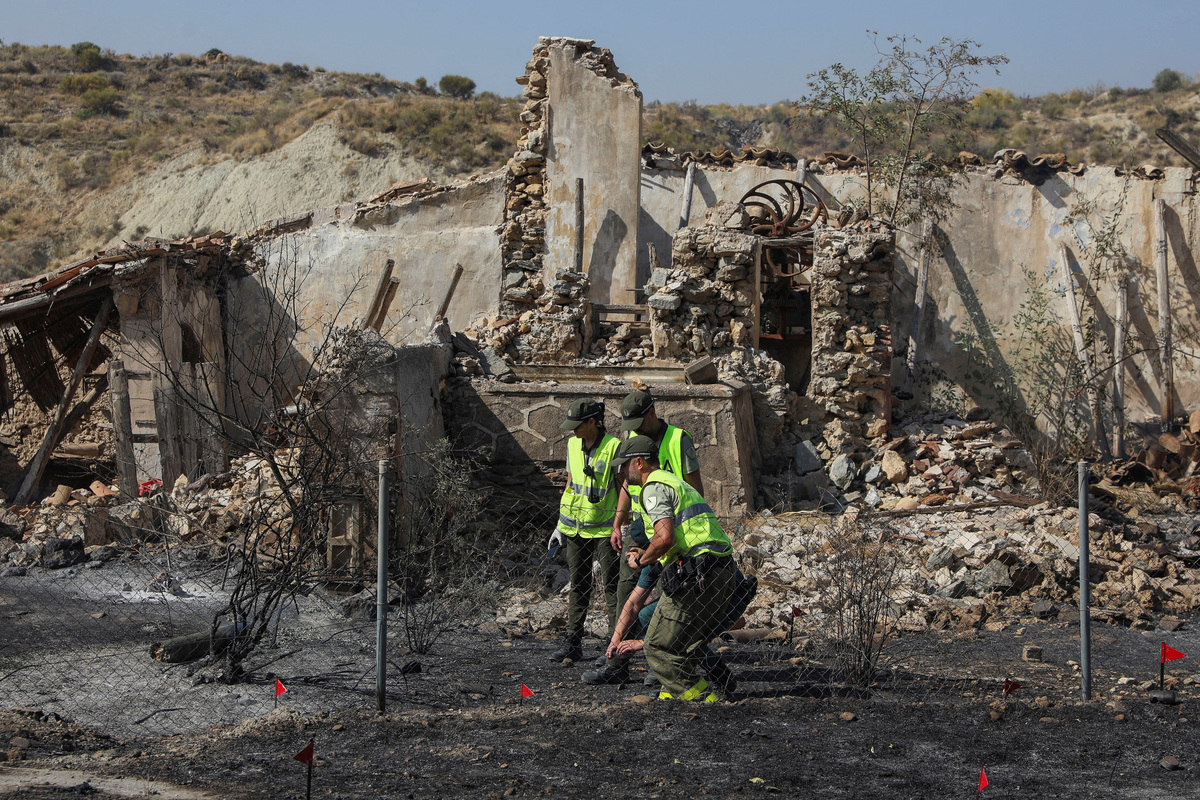 Members of the Spanish Civil Guard conduct an investigation during a wildfire in Almocaizar, in the vicinity of Los Gallardos, in Almeria, Spain, July 10, 2026. REUTERS/Loyola Perez de Villegas Muniz