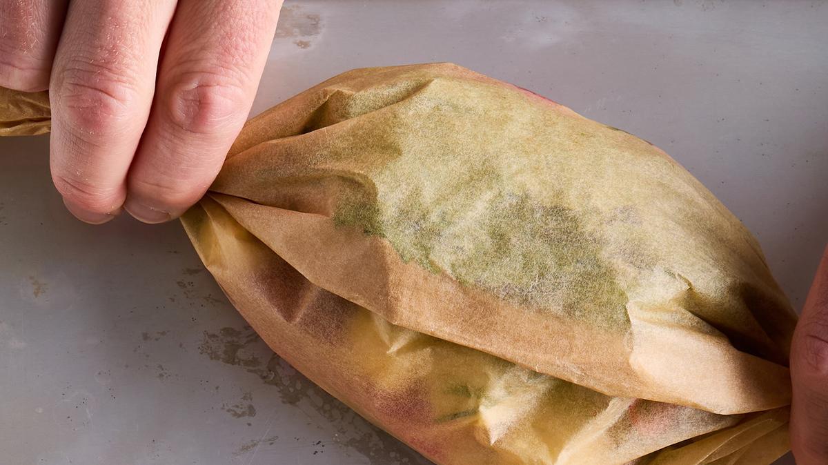 Parchment-steamed fish with buttered radishes. Wrapping the fish in parchment allows it to steam easily.