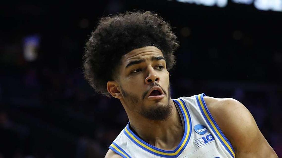  Mar 20, 2026; Philadelphia, PA, USA; UCLA Bruins guard Eric Freeny (8) makes a pass against UCF Knights center John Bol (7) in the second half during a first round game of the men's 2026 NCAA Tournament at Xfinity Mobile Arena. Mandatory Credit: Bill Streicher-Imagn Images | Bill Streicher-Imagn Images 