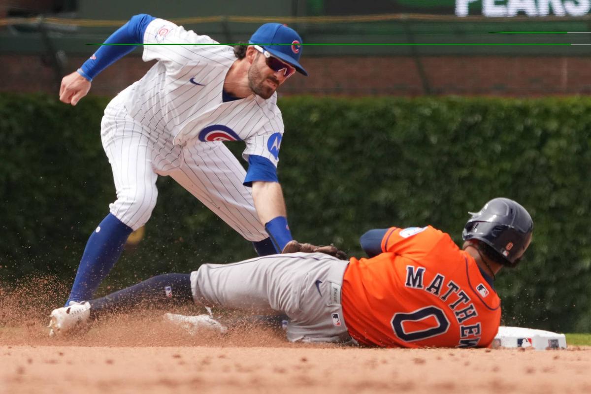  May 23, 2026; Chicago, Illinois, USA; Chicago Cubs shortstop Dansby Swanson (7) tags out Houston Astros center fielder Brice Matthews (0) at second base on a steal attempt during the ninth inning at Wrigley Field. Mandatory Credit: David Banks-Imagn Images