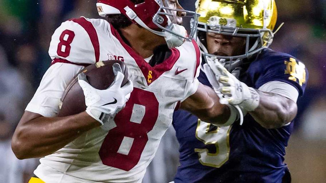  Oct 18, 2025; South Bend, Indiana, USA; Southern California Trojans wide receiver Ja'Kobi Lane (8) breaks a tackle by Notre Dame Fighting Irish safety Tae Johnson (9) during the second half at Notre Dame Stadium. Mandatory Credit: Michael Caterina-Imagn Images | Michael Caterina-Imagn Images 
