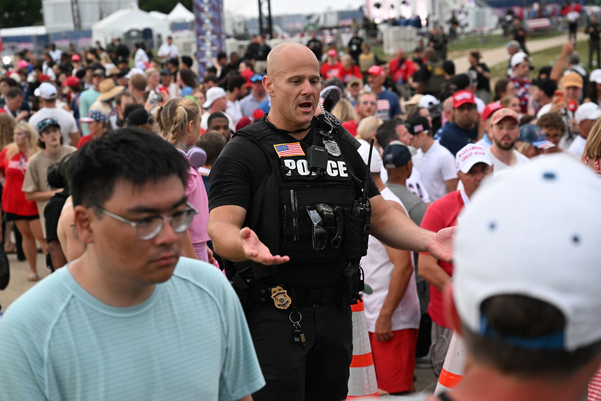 A police officer in crowds of America 250 attendees the National Mall in Washington, as officials ordered an evacuation due to severe weather approaching, on July 4, 2026. Federal and local officials scrambled to safely evacuate thousands of people from the National Mall and into nearby Smithsonian museums and federal buildings, according to multiple officials. (Kenny Holston/The New York Times)