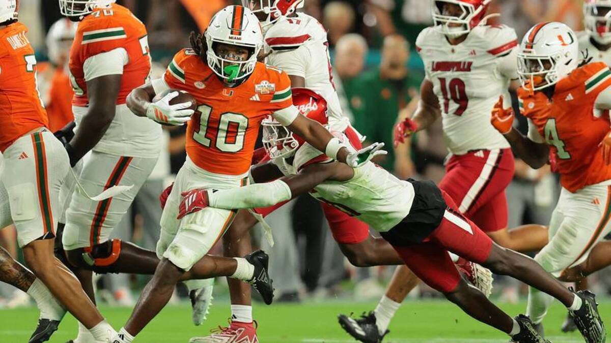  Oct 17, 2025; Miami Gardens, Florida, USA; Miami Hurricanes wide receiver Malachi Toney (10) carries the football against Louisville Cardinals linebacker T.J.C.apers (11) during the second quarter at Hard Rock Stadium. Mandatory Credit: Sam Navarro-Imagn Images | Sam Navarro-Imagn Images 