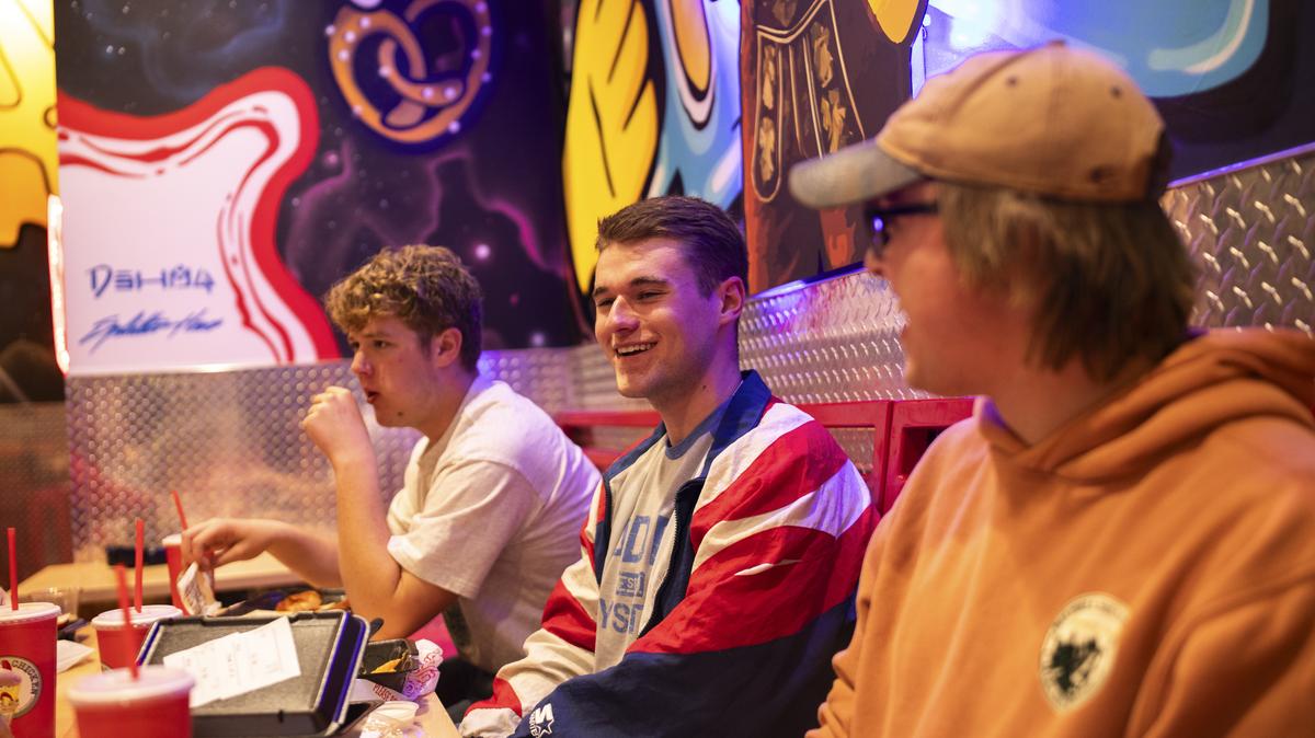 Dylan Pfaffenbach, center, a Republican student leader at Carroll University, at a restaurant near the campus in Waukesha, Wis., Nov. 25, 2025. Some Gen Z men who voted for Donald Trump are dismayed by his time in office, but say they don't hear an appealing pitch from Democrats, either