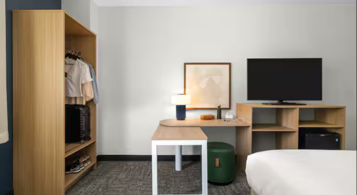  The open closet and convertible desk are standard in Spark by  Hilton  hotel rooms. Photo courtesy of Spark by  Hilton 