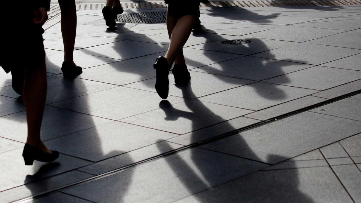Female office workers wearing high heels and clothes of the same colour walk at a business district in Tokyo, Japan, June 4, 2019. REUTERS/Kim Kyung-Hoon