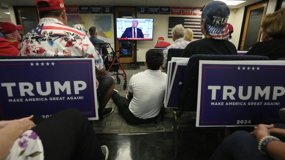 Phoenix residents watch presidential candidate Donald Trump speak at the Republican National Convention on July 18, 2024. 