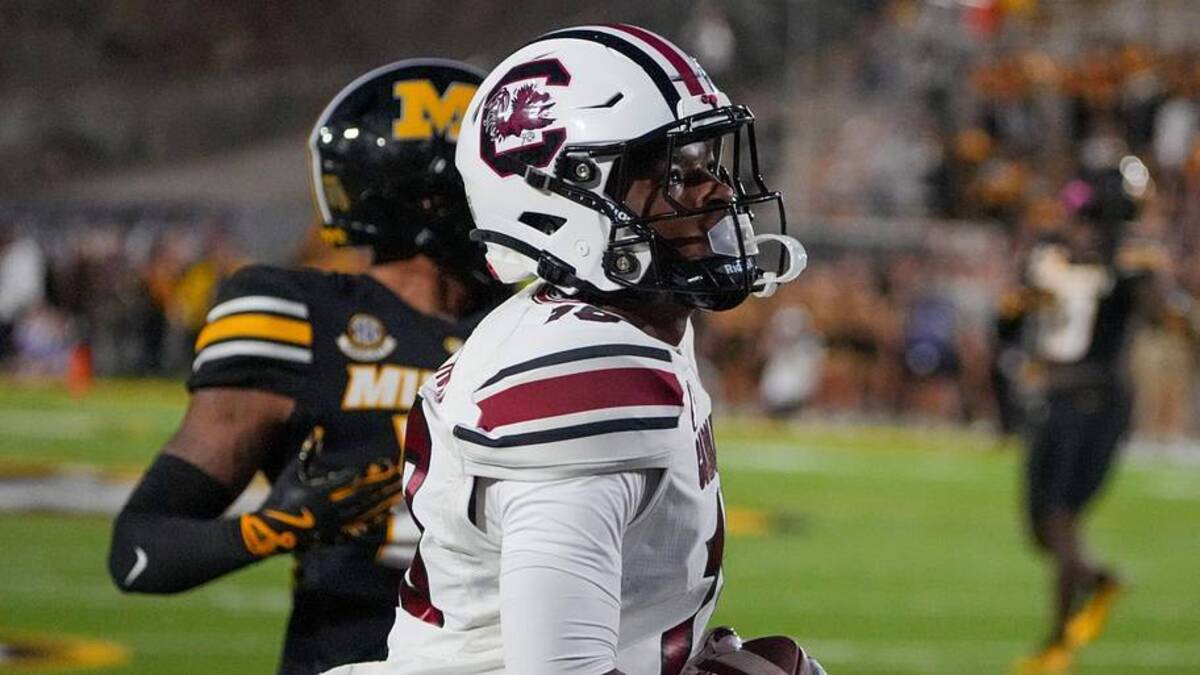  Sep 20, 2025; Columbia, Missouri, USA; South Carolina Gamecocks wide receiver Brian Rowe Jr. (18) catches a pass for a touchdown as Missouri Tigers cornerback Drey Norwood (12) looks on during the first half of the game at Faurot Field at Memorial Stadium. Mandatory Credit: Denny Medley-Imagn Images | Denny Medley-Imagn Images 