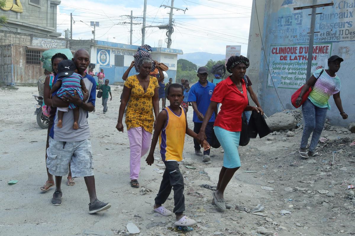 Residents walk along a street while fleeing their homes in Cite Soleil after rival gang clashes in Haiti's capital worsened over the weekend, in Port-au-Prince, Haiti, May 11, 2026. REUTERS/Fildor Pq Egeder