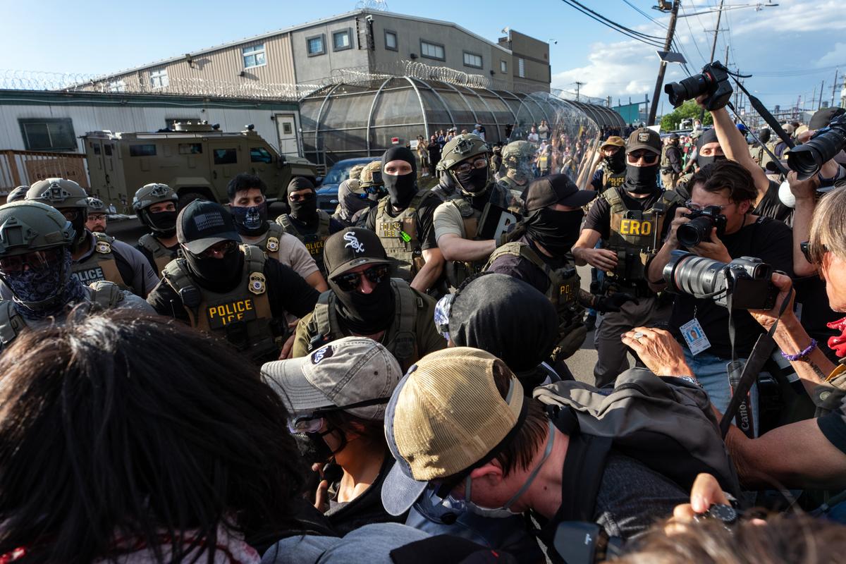 Protesters scuffle with masked immigration agents during a demonstration outside Delaney Hall, an immigration detention center in Newark, N.J., on Thursday evening, May 28, 2026. For nearly a week, relatives of migrants at Delaney Hall have said that some detainees have been on a hunger strike at the facility. Federal officials have denied that a hunger strike is taking place. (Todd Heisler/The New York Times)
