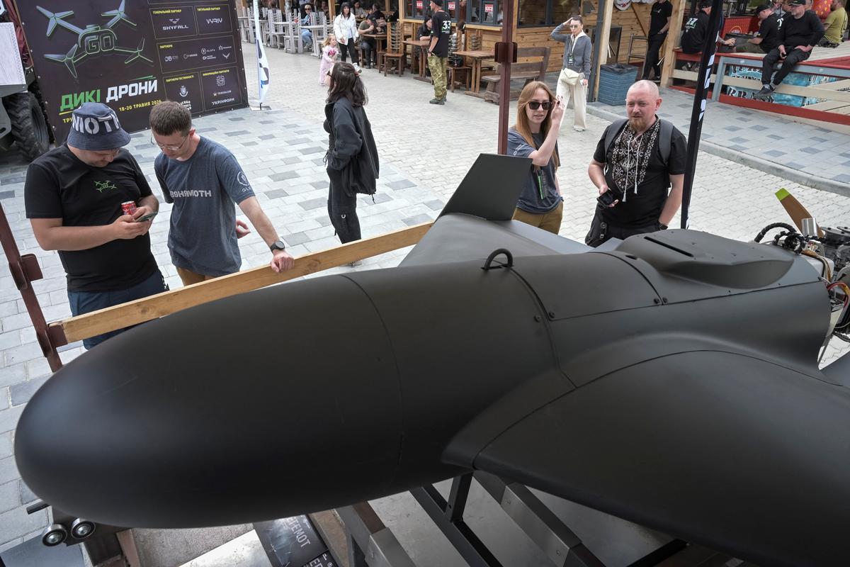 Visitors of the Wild Drones competition look at a Behemoth middle-range strike drone at an exhibition, amid Russia's attack on Ukraine, in the town of Truskavets, Lviv region, Ukraine, May 20, 2026. REUTERS/Stringer