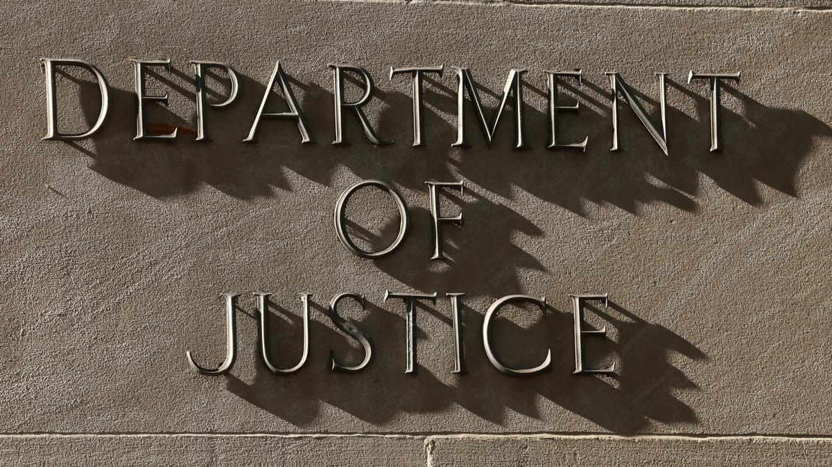 FILE PHOTO: A sign for the U.S. Department of Justice in Washington, D.C., April 6, 2026. REUTERS/Kevin Lamarque/File Photo