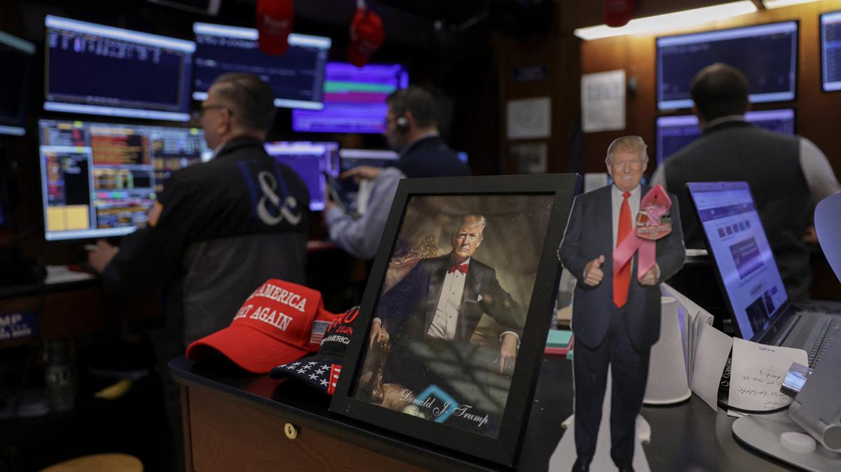 An image of U.S. President Donald Trump as traders work on the floor at the New York Stock Exchange (NYSE) in New York City, U.S., May 15, 2026. REUTERS/Jeenah Moon