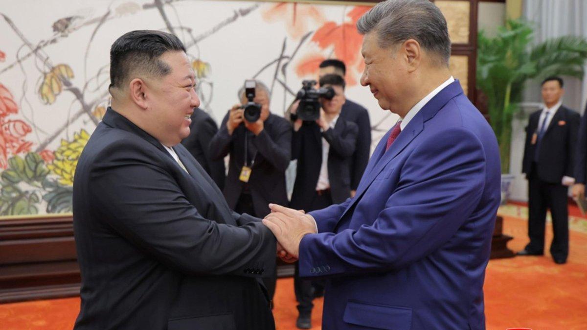 Chinese President Xi Jinping (R) will likely visit North Korea as early as next week, sources said Wednesday. In this photo, Xi shakes hands with North Korean leader Kim Jong Un during a meeting in Beijing. File Photo by KCNA/EPA