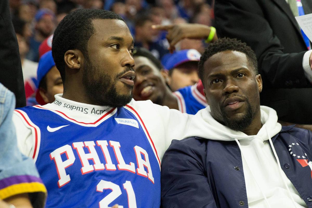  Musical recording artist Meek Mill (L) and actor Kevin Hart (R) during the 2018 NBA playoffs between the Philadelphia 76ers and the Miami Heat at Wells Fargo Center. Bill Streicher-USA TODAY Sports