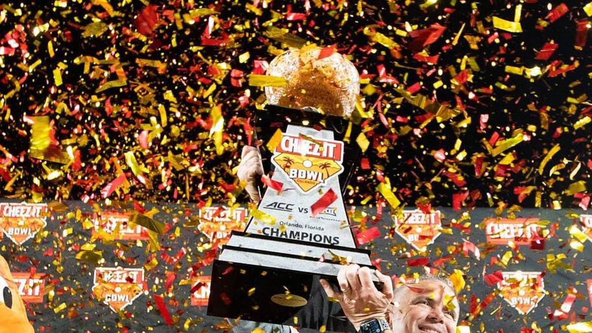  Florida State Seminoles head coach Mike Norvell holds up the Cheez-It Bowl trophy after the Seminoles defeated the Oklahoma Sooners 35-32 in the Cheez-It Bowl at Camping World Stadium on Thursday, Dec. 29, 2022. | USA TODAY Network via Reuters Connect 