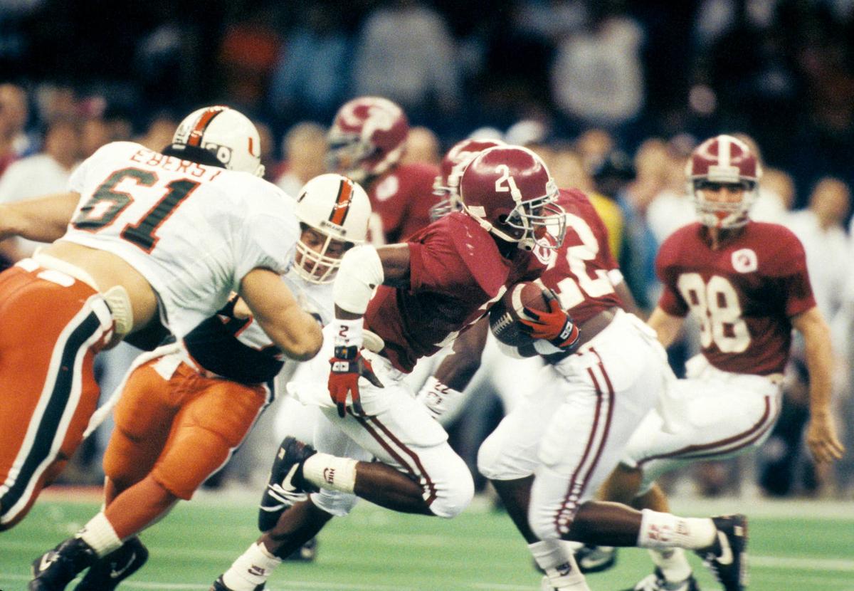  Alabama Crimson receiver David Palmer carries the ball past teammate Dabo Swinney against the Miami Hurricanes during the 1993 Sugar Bowl at the Superdome. RVR Photos-USA TODAY Sports