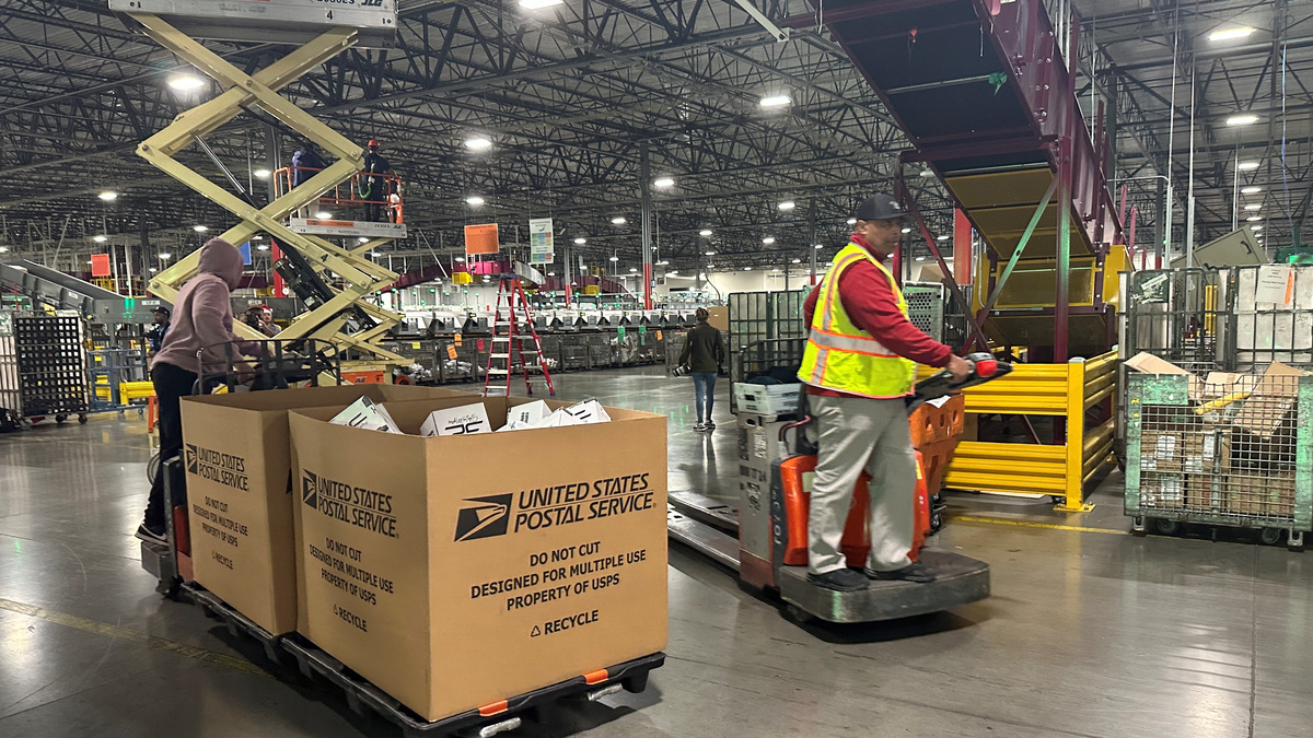 Employees work as the largest United States Postal Service (USPS) facility gears up for the busiest shipping time of the year, in Los Angeles, California, U.S. November 30, 2023. REUTERS/Jorge Garcia