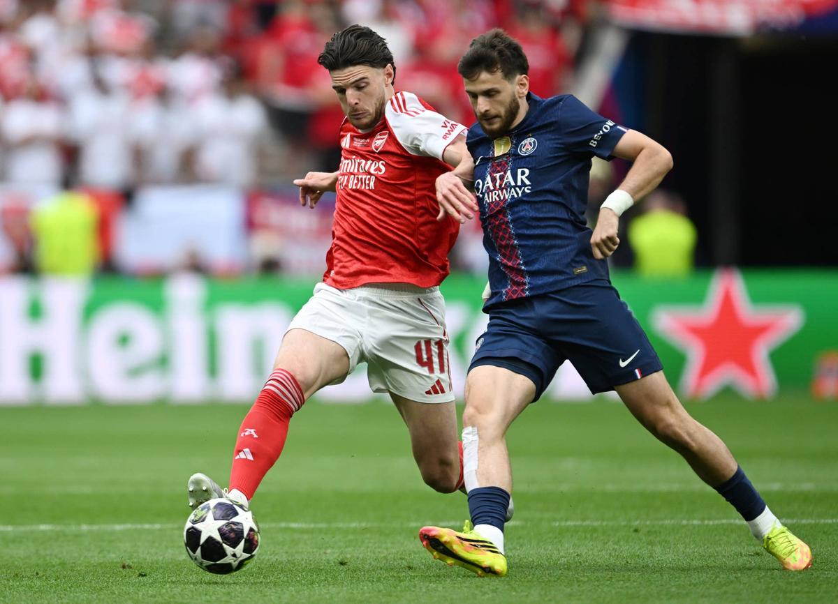 Declan Rice of Arsenal is challenged by Khvicha Kvaratskhelia of Paris Saint-Germain during the UEFA Champions League Final 2026 match between Paris Saint-Germain and Arsenal FC at Puskas Arena on May 30, 2026 in Budapest, Hungary. (Photo by Stuart MacFarlane/Arsenal FC via Getty Images) Photo by Stuart MacFarlane/Arsenal FC via Getty Images