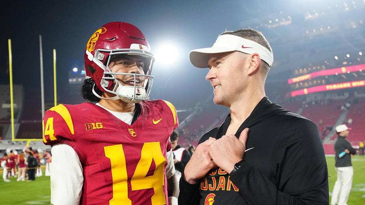  Nov 29, 2025; Los Angeles, California, USA; Southern California Trojans quarterback Jayden Maiava (14) and head coach Lincoln Riley react after the game against the UCLA Bruins at United Airlines Field at Los Angeles Memorial Coliseum. Mandatory Credit: Kirby Lee-Imagn Images | Kirby Lee-Imagn Images 